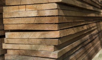 wide plank darker wood boards freshly cut and stacked